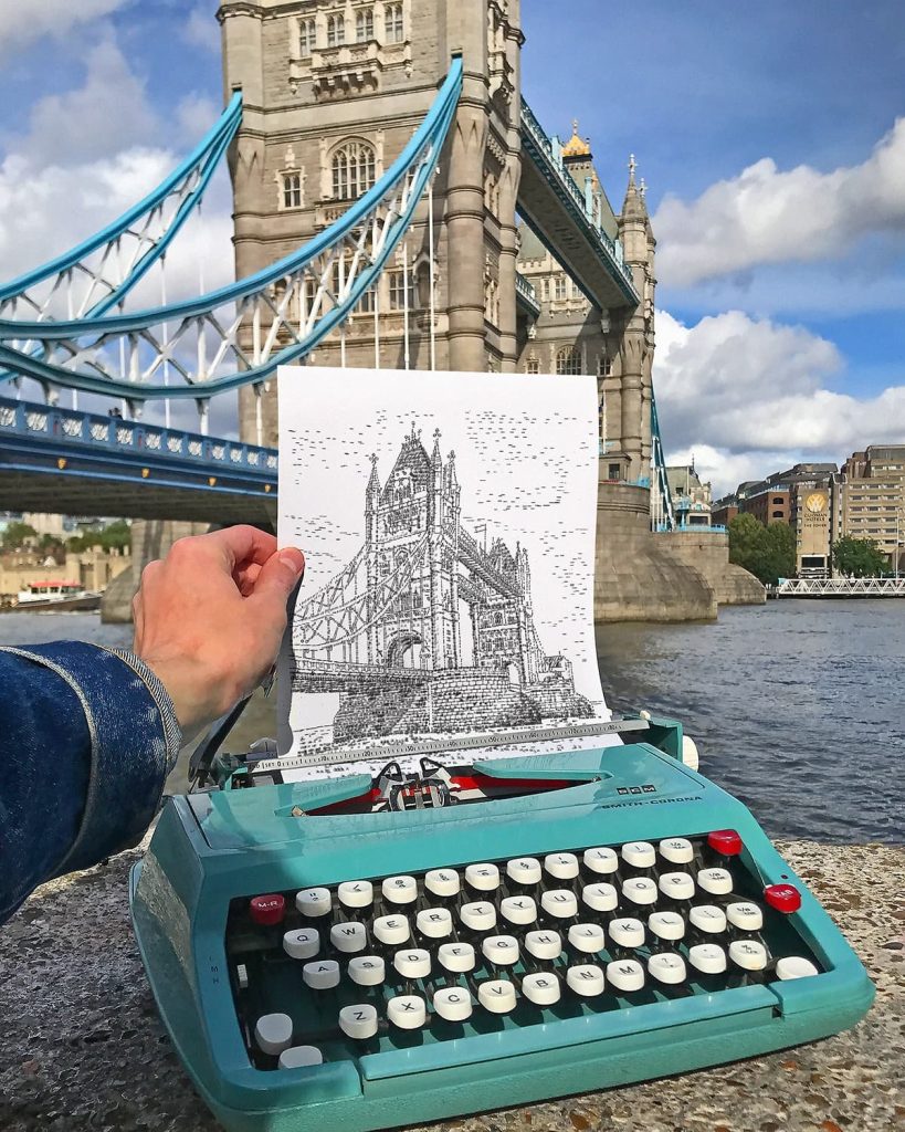5th october 2021 artist james cook works with indepth stories documentary team on location at londons tower bridge creating typewriter art usi