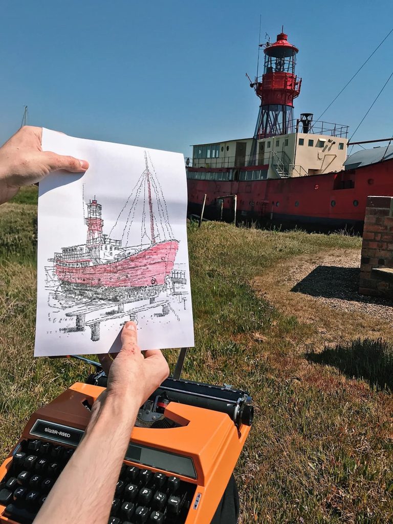 1st august 2020 artist james cook sits with a deckchair creating typewriter art beside a lightship in tollesbury marina located in essex